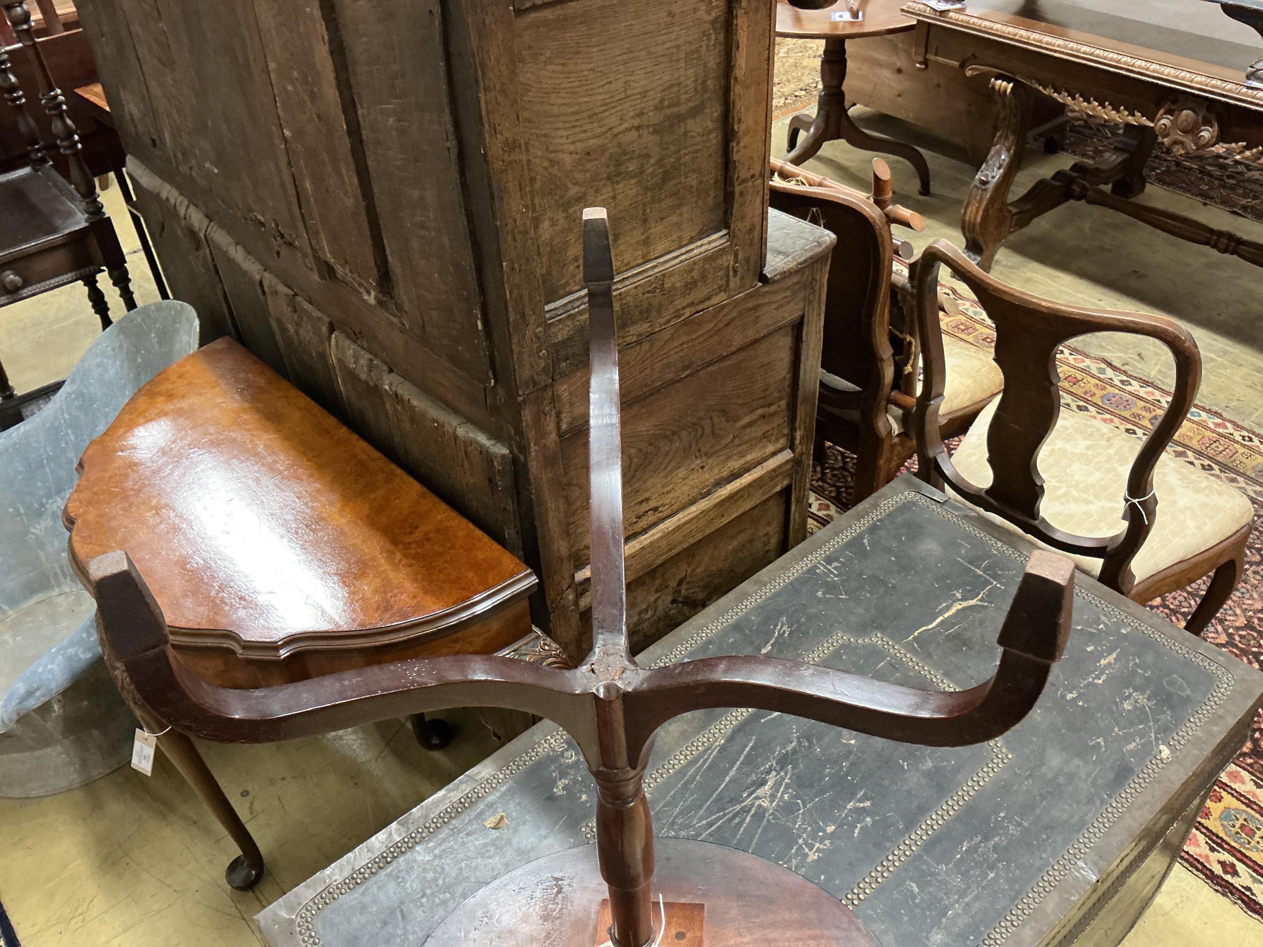 A George III banded mahogany oval tripod wine table, width 52cm, height 76cm
